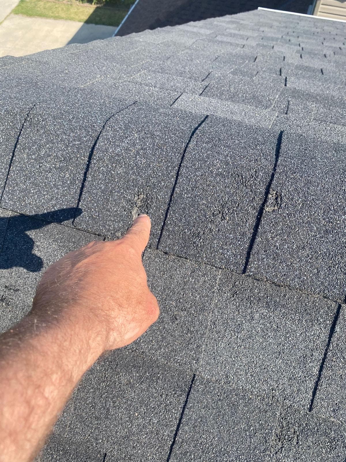 Hail impact marks and granule loss across asphalt shingles